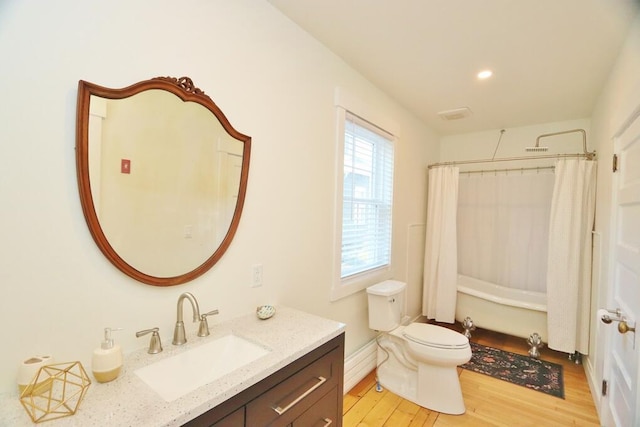 228 French St, Bangor, ME 04401 - full bath featuring vanity, wood finished floors, toilet, shower / bath combo with shower curtain, and recessed lighting