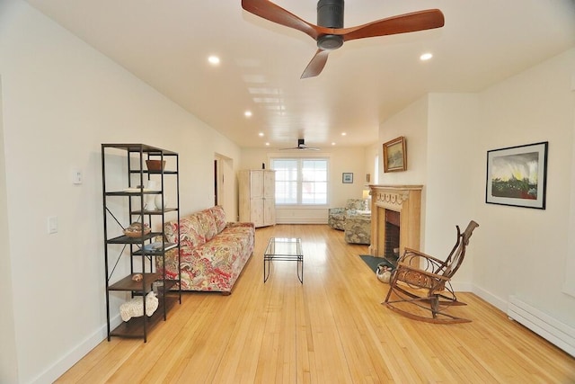 228 French St, Bangor, ME 04401 - sitting room featuring a baseboard radiator, ceiling fan, a fireplace with flush hearth, hardwood / wood-style floors, and baseboards