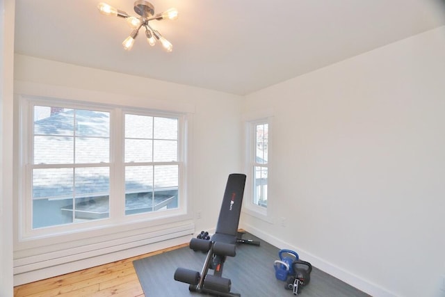 228 French St, Bangor, ME 04401 - workout room featuring a chandelier and baseboards