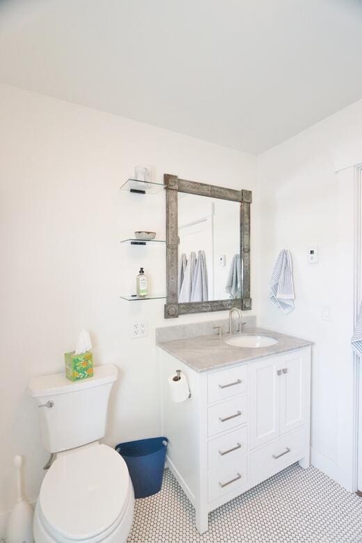 228 French St, Bangor, ME 04401 - bathroom featuring vanity, toilet, and baseboards