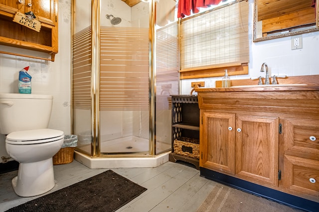 72 Logan Cir, Waterboro, ME 04030 - bathroom featuring toilet, vanity, a shower stall, and wood-type flooring