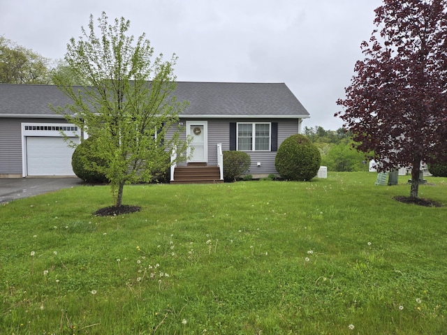 101 Streamside Ln Unit 21, Bangor, ME 04401 - view of front of home with a garage, a front yard, driveway, and roof with shingles