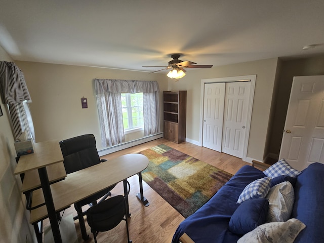 101 Streamside Ln Unit 21, Bangor, ME 04401 - living room with baseboard heating, light wood finished floors, ceiling fan, and baseboards
