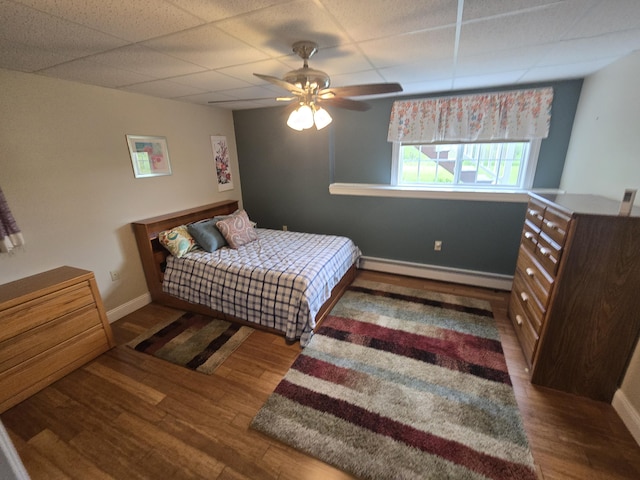 101 Streamside Ln Unit 21, Bangor, ME 04401 - bedroom featuring wood finished floors, a drop ceiling, baseboard heating, baseboards, and a ceiling fan
