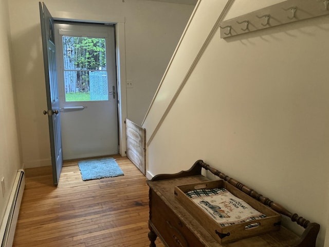 34 Highview Ave, Hancock, ME 04640 - doorway with baseboard heating, light wood-type flooring, and baseboards