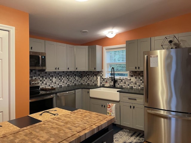 412 Post Rd Unit 253, Wells, ME 04090 - kitchen featuring appliances with stainless steel finishes, a sink, lofted ceiling, backsplash, and wood counters