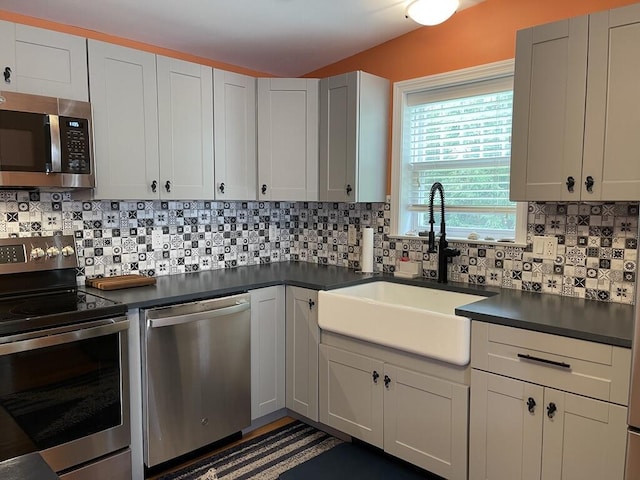 412 Post Rd Unit 253, Wells, ME 04090 - kitchen featuring stainless steel appliances, a sink, dark countertops, and tasteful backsplash