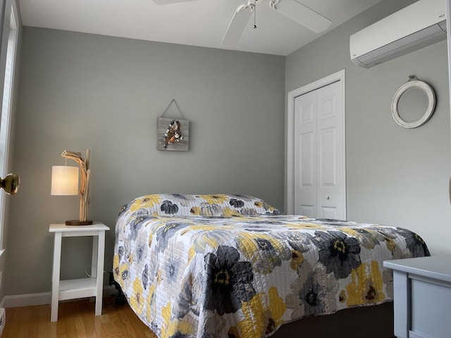 412 Post Rd Unit 253, Wells, ME 04090 - bedroom featuring a wall mounted air conditioner, wood finished floors, a closet, ceiling fan, and baseboards