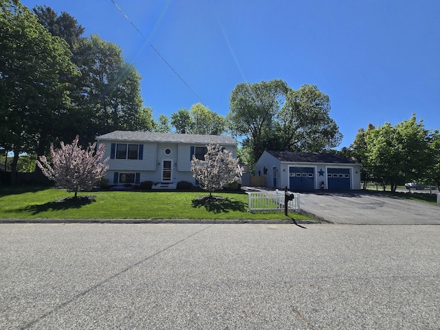 5 Roland Ave, Lewiston, ME 04240 - split foyer home featuring driveway, a front lawn, and an outdoor structure