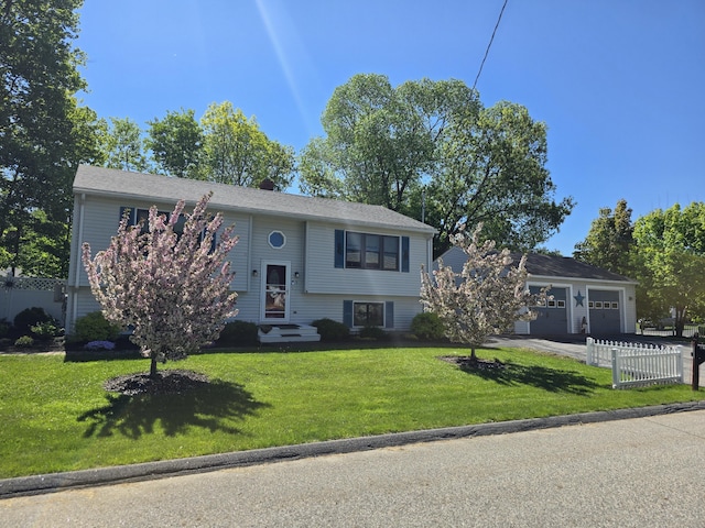 5 Roland Ave, Lewiston, ME 04240 - raised ranch featuring a garage, driveway, and entry steps