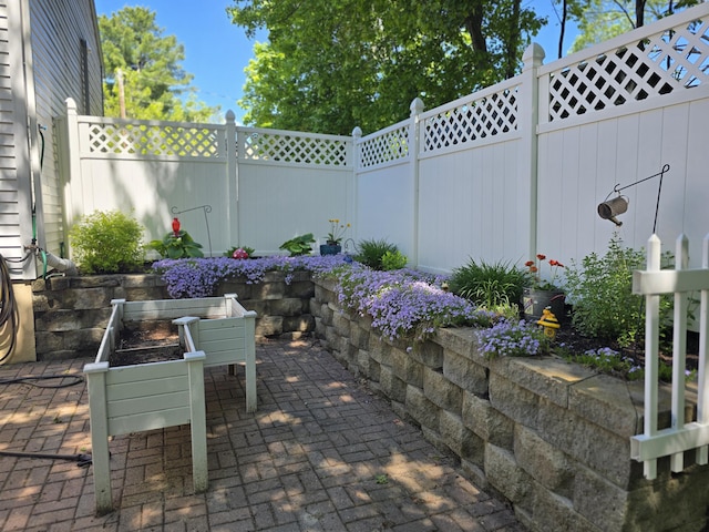 5 Roland Ave, Lewiston, ME 04240 - fenced backyard with a patio
