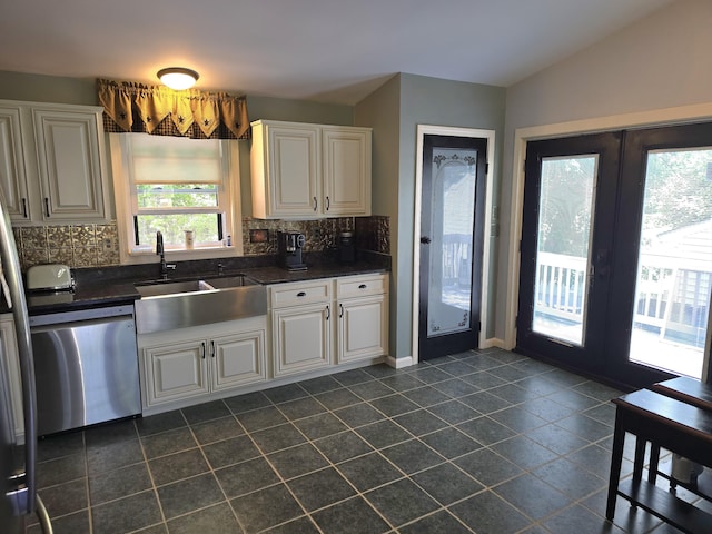 5 Roland Ave, Lewiston, ME 04240 - kitchen with dishwasher, dark tile patterned floors, dark countertops, and tasteful backsplash