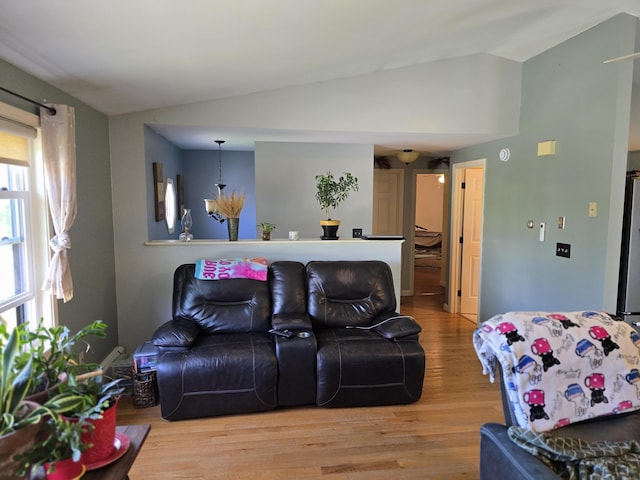 5 Roland Ave, Lewiston, ME 04240 - living area featuring vaulted ceiling, wood finished floors, and a chandelier
