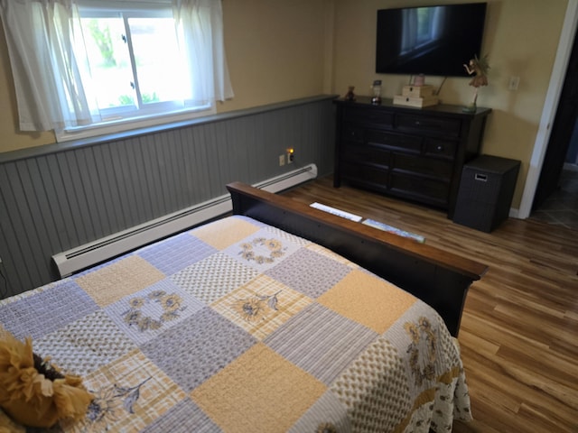 5 Roland Ave, Lewiston, ME 04240 - bedroom with wainscoting, wood finished floors, and baseboard heating