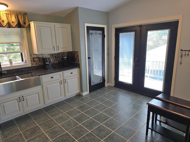 5 Roland Ave, Lewiston, ME 04240 - kitchen with dark tile patterned flooring, dark countertops, french doors, and tasteful backsplash