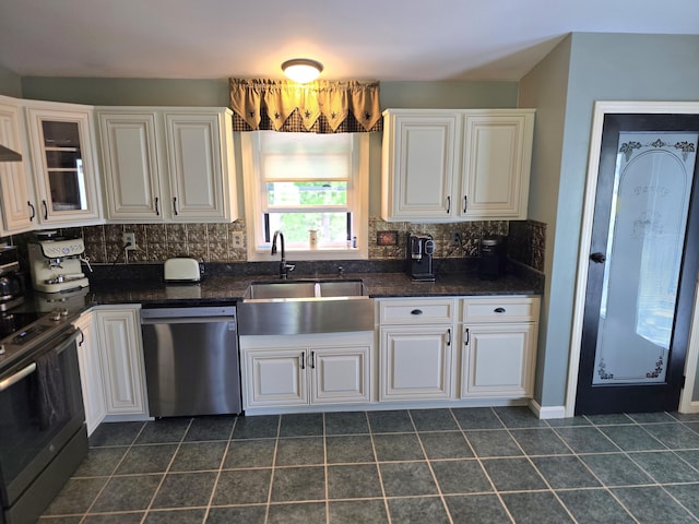5 Roland Ave, Lewiston, ME 04240 - kitchen with stainless steel appliances, a sink, backsplash, and white cabinets
