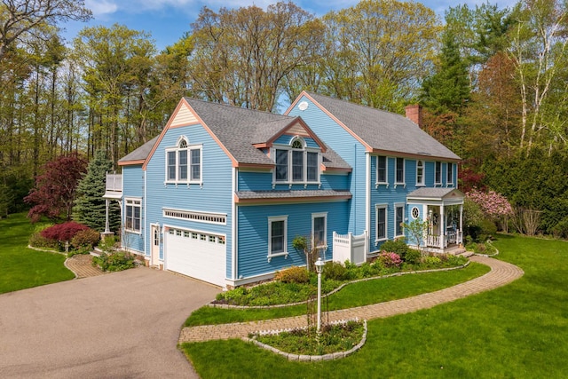 31 Rebecca Rd, Ogunquit, ME 03907 - view of front of house with driveway, an attached garage, a front lawn, and roof with shingles