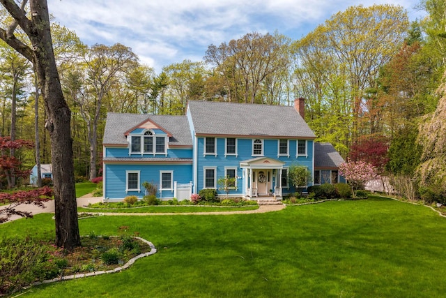 31 Rebecca Rd, Ogunquit, ME 03907 - view of front of property featuring a chimney and a front lawn