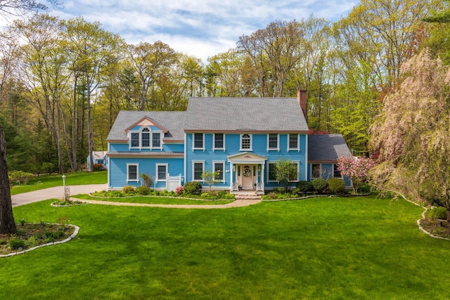 31 Rebecca Rd, Ogunquit, ME 03907 - view of front facade featuring a chimney and a front yard