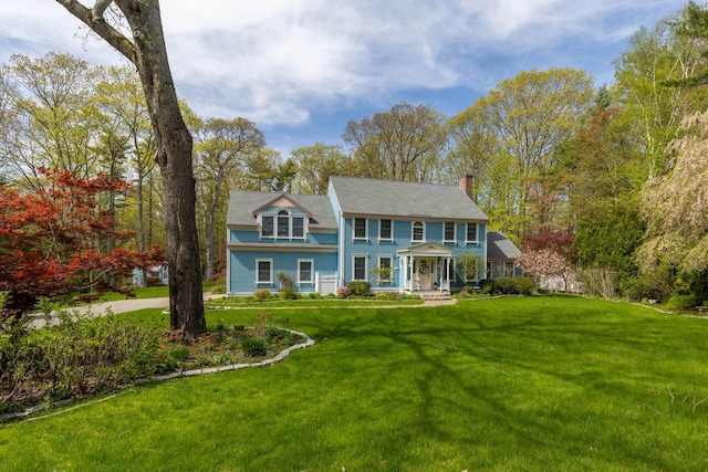 31 Rebecca Rd, Ogunquit, ME 03907 - colonial inspired home featuring a chimney, a front lawn, and a porch