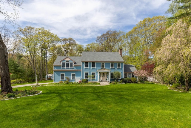 31 Rebecca Rd, Ogunquit, ME 03907 - colonial house with a chimney, a front yard, and a porch