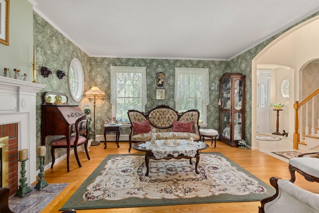 31 Rebecca Rd, Ogunquit, ME 03907 - sitting room featuring wallpapered walls, arched walkways, stairway, baseboard heating, and crown molding