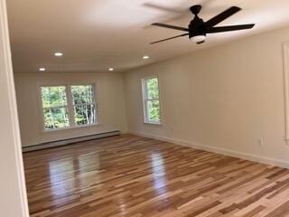 12 Windsor Rd, Ellsworth, ME 04605 - unfurnished room with a baseboard radiator, recessed lighting, wood finished floors, ceiling fan, and baseboards