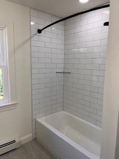 12 Windsor Rd, Ellsworth, ME 04605 - bathroom with a baseboard radiator, baseboards, and shower / bath combination