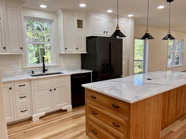 12 Windsor Rd, Ellsworth, ME 04605 - kitchen with black appliances, a sink, light wood-type flooring, light stone counters, and white cabinetry