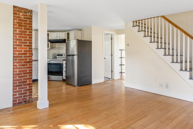 185 Depot Rd, Eliot, ME 03903 - unfurnished living room with light wood-type flooring, baseboards, and stairs