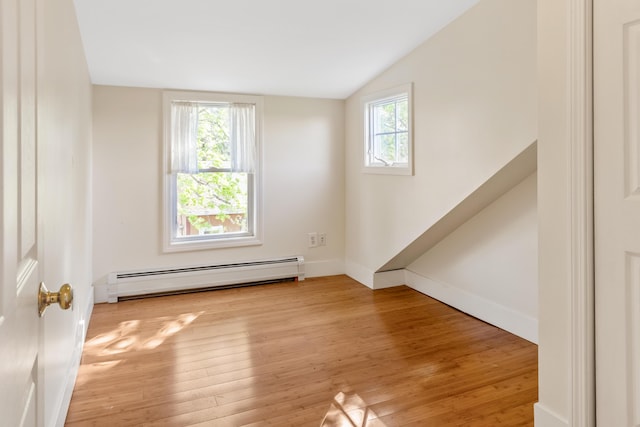 185 Depot Rd, Eliot, ME 03903 - unfurnished room with a baseboard heating unit, plenty of natural light, lofted ceiling, and light wood-style floors