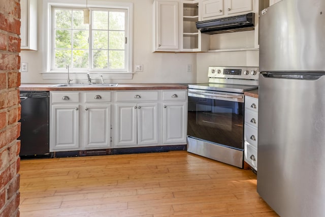 185 Depot Rd, Eliot, ME 03903 - kitchen featuring appliances with stainless steel finishes, range hood, white cabinets, a sink, and light wood-style flooring