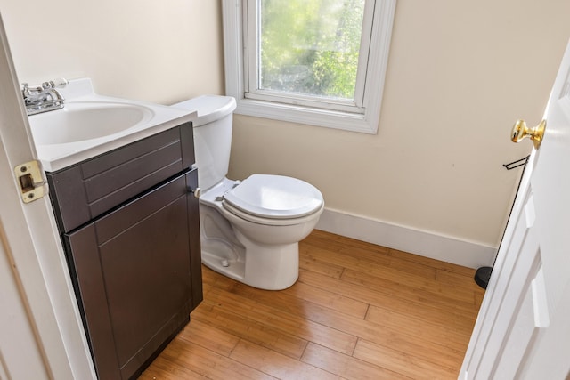 185 Depot Rd, Eliot, ME 03903 - half bathroom featuring toilet, vanity, and wood finished floors