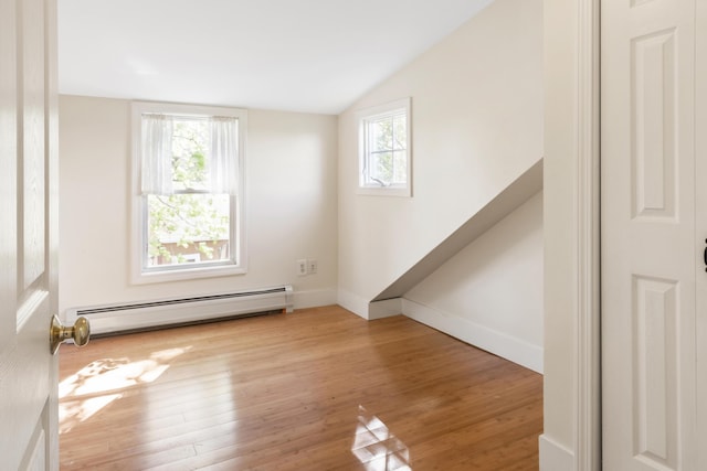185 Depot Rd, Eliot, ME 03903 - spare room with a baseboard heating unit, healthy amount of natural light, wood finished floors, and lofted ceiling