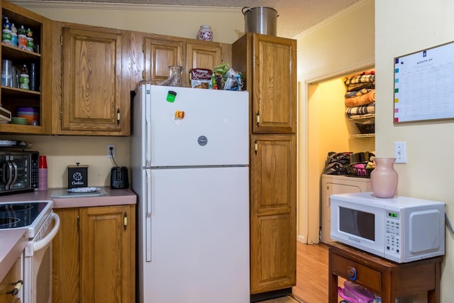 31 Lakeview Dr, West Bath, ME 04530 - kitchen with white appliances, brown cabinets, and light wood-type flooring