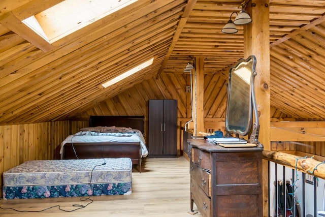 31 Lakeview Dr, West Bath, ME 04530 - bedroom featuring vaulted ceiling, wooden walls, a skylight, and light wood finished floors