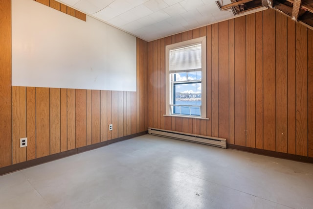 27 Ocean Ave Extension Unit 2, York, ME 03909 - unfurnished room featuring a baseboard heating unit, concrete floors, and wooden walls