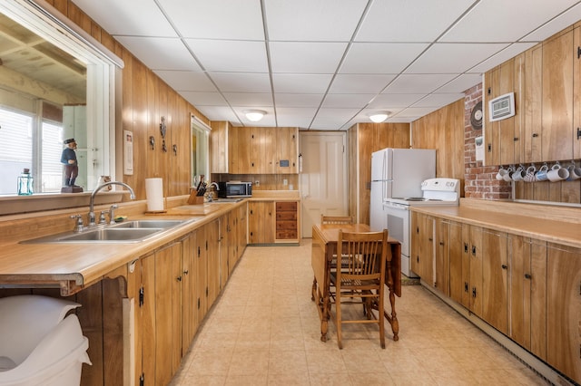 27 Ocean Ave Extension Unit 2, York, ME 03909 - kitchen featuring white range with electric cooktop, a sink, wood walls, stainless steel microwave, and light countertops
