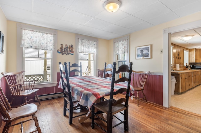 27 Ocean Ave Extension Unit 2, York, ME 03909 - dining room featuring a baseboard radiator, healthy amount of natural light, light wood-style flooring, and a paneled ceiling