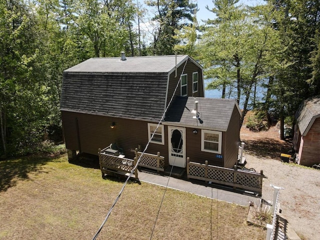 101 Brooks & Dunn Road, Otis, ME 04605 - rear view of property featuring a gambrel roof, a shingled roof, and a lawn