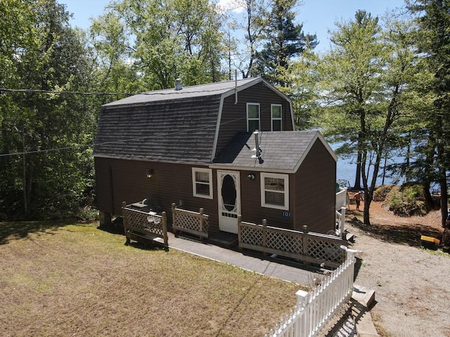 101 Brooks & Dunn Road, Otis, ME 04605 - view of front facade featuring a gambrel roof, a front lawn, and roof with shingles