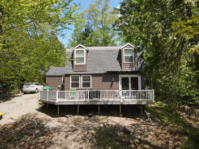 101 Brooks & Dunn Road, Otis, ME 04605 - back of property with a deck and roof with shingles