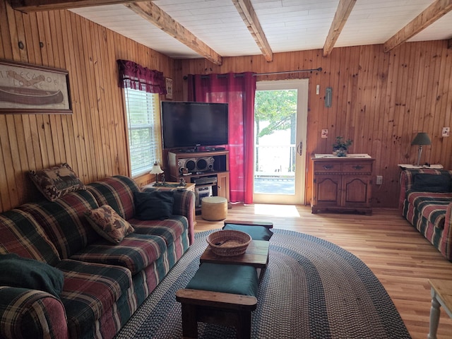 101 Brooks & Dunn Road, Otis, ME 04605 - living room featuring beamed ceiling, light wood-style flooring, and wood walls