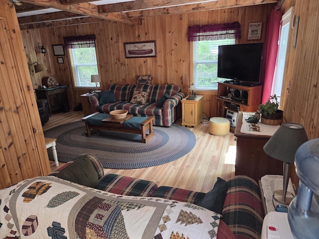 101 Brooks & Dunn Road, Otis, ME 04605 - living room featuring wood walls, wood finished floors, and beam ceiling