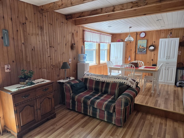 101 Brooks & Dunn Road, Otis, ME 04605 - living area featuring light wood-style flooring, wood walls, and wood ceiling with exposed beams