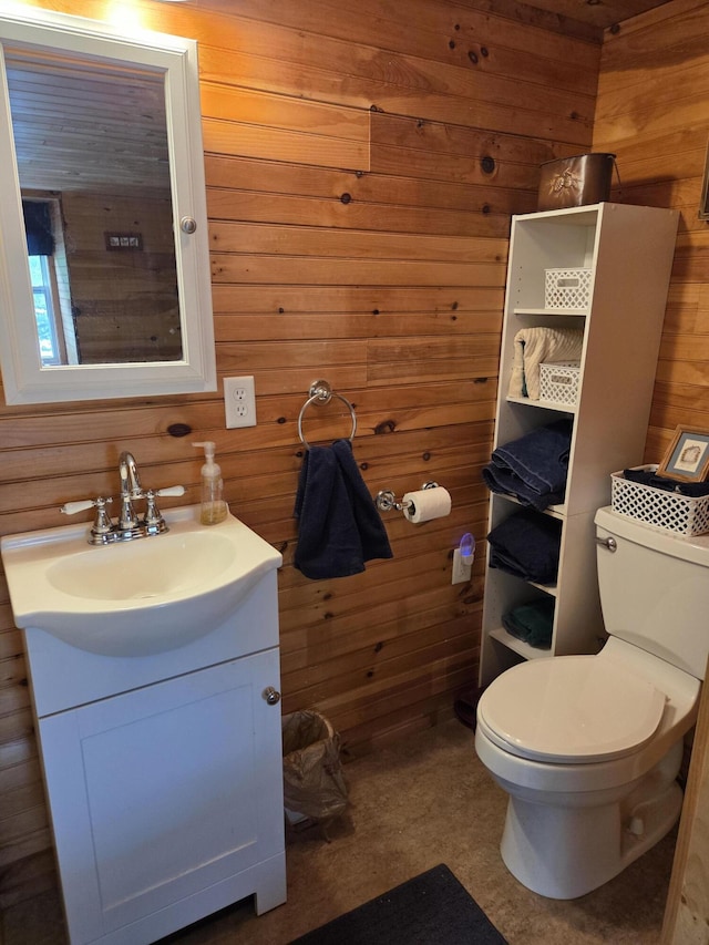 101 Brooks & Dunn Road, Otis, ME 04605 - bathroom with wood walls, vanity, and toilet