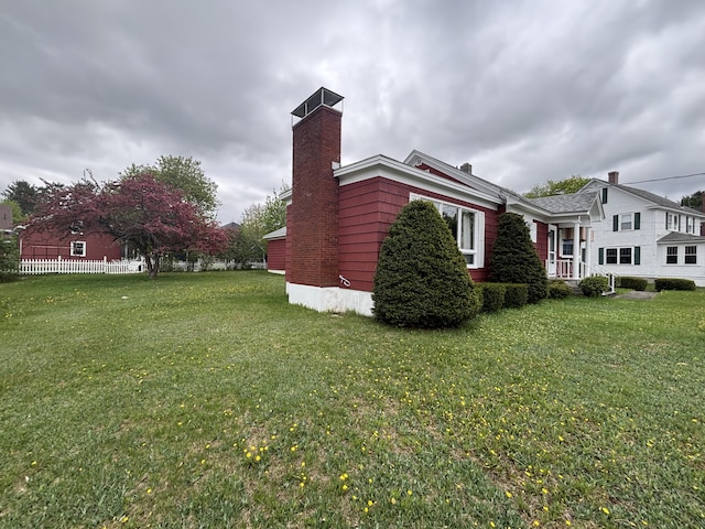 187 Maine Ave, Millinocket, ME 04462 - view of home's exterior featuring a chimney and a yard