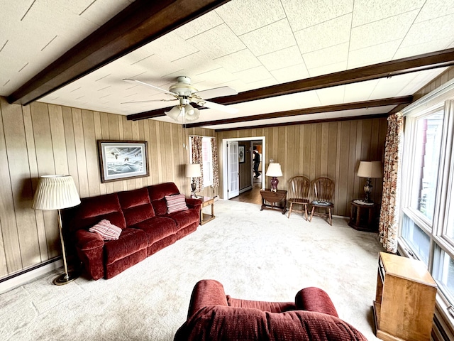 187 Maine Ave, Millinocket, ME 04462 - carpeted living room featuring beam ceiling, wooden walls, and ceiling fan