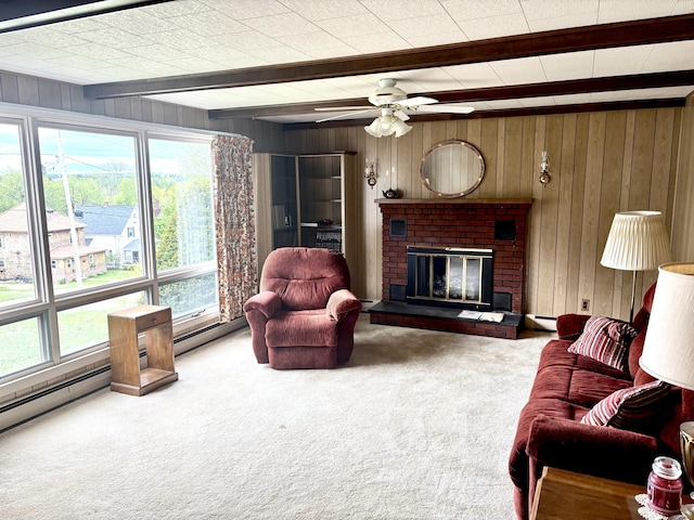187 Maine Ave, Millinocket, ME 04462 - living area featuring beam ceiling, carpet flooring, wood walls, a brick fireplace, and ceiling fan