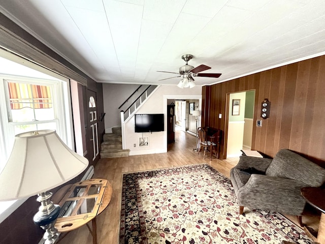 187 Maine Ave, Millinocket, ME 04462 - living room with wood finished floors, stairway, ceiling fan, and wood walls